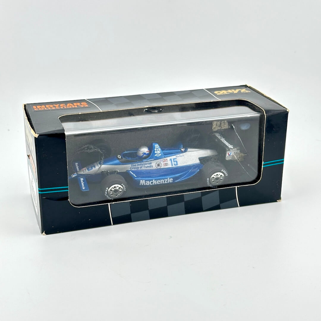 Model car in a box with a clear front window on a white background