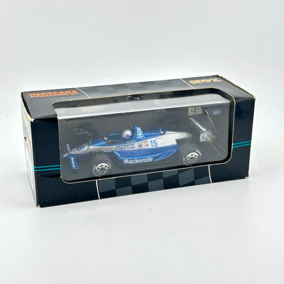 Model car in a box with a clear front window on a white background