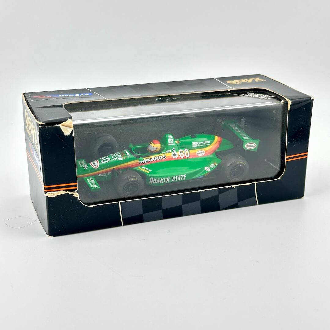 Model car in a transparent box with visible branding on a white background