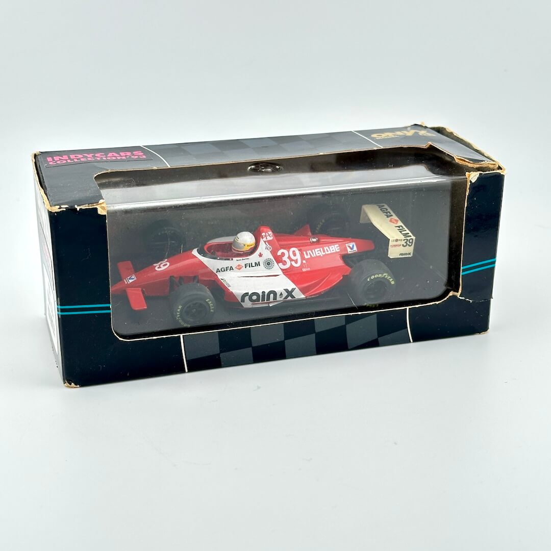 Model Indy car in packaging with clear window and branding against white background.