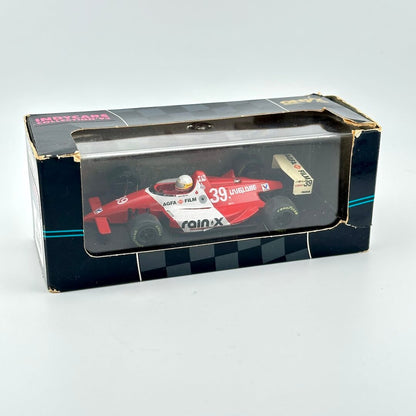 Model Indy car in packaging with clear window and branding against white background.
