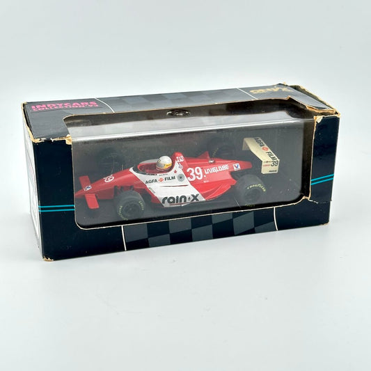 Model Indy car in packaging with clear window and branding against white background.