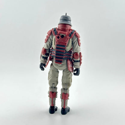 Action figure of a soldier shown from the back, wearing a beige jumpsuit with red armor plating, a gray helmet, and black boots.