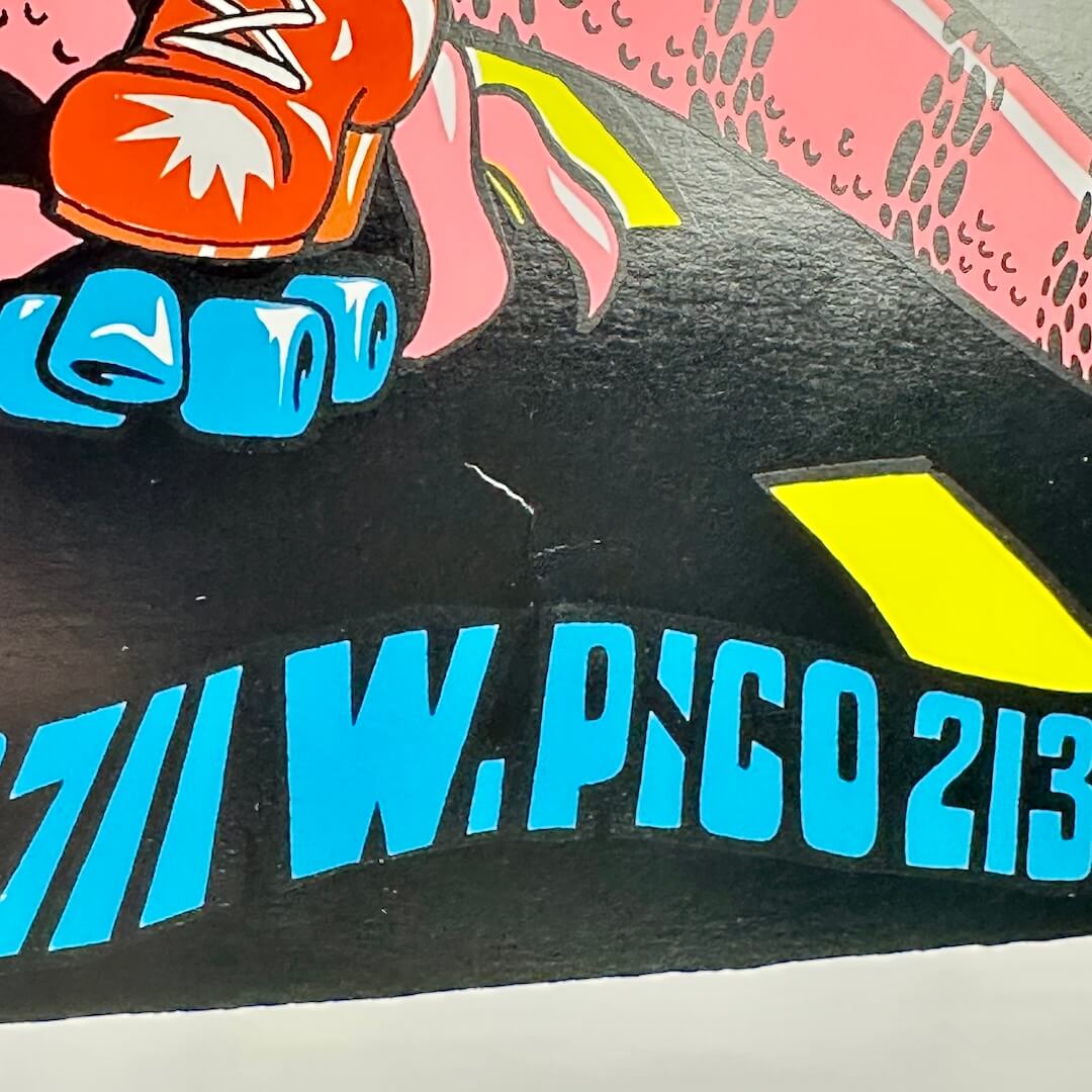 Close up of crease/dent to poster above venue address. 