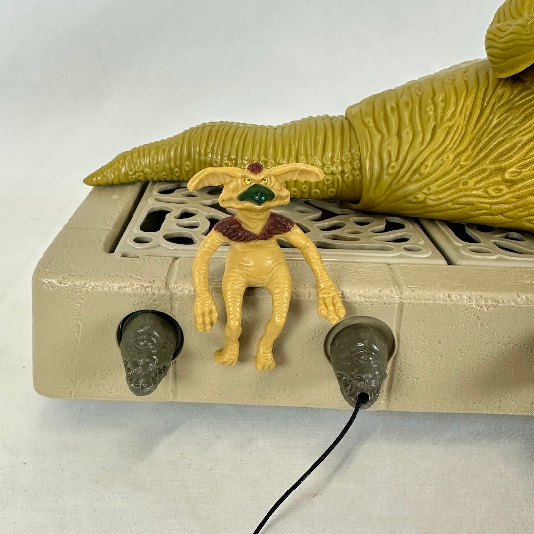 Close up of Jabba's pet, Crumb, and gargoyles on front of base. 