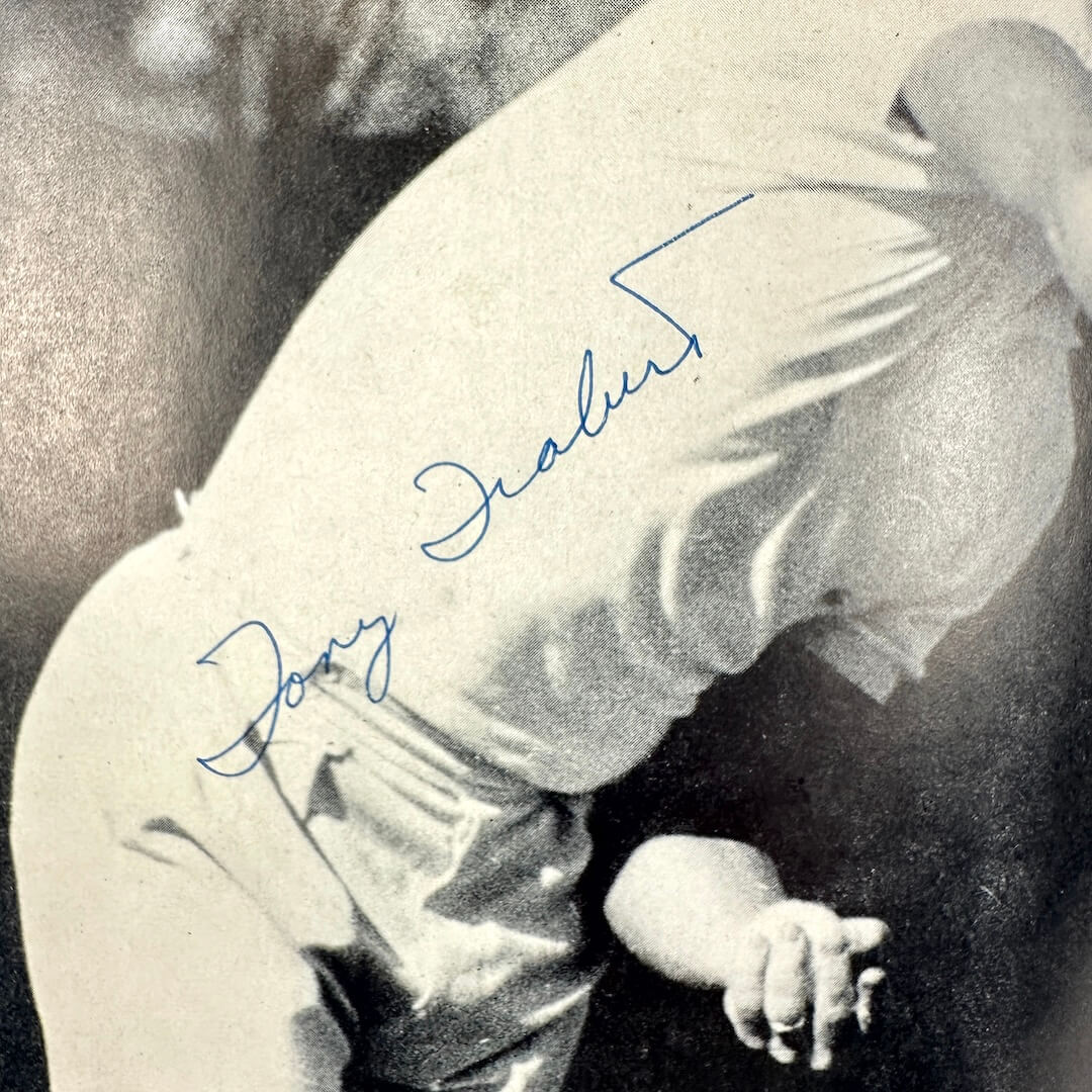 Close up of Tony Trabert's signature on photo in program. 