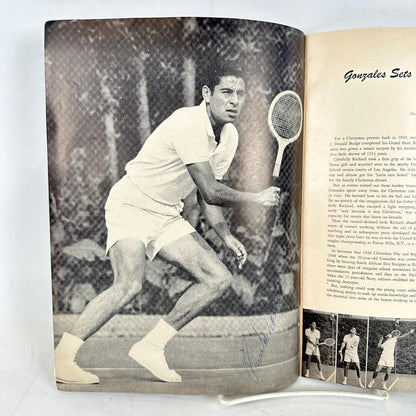 Open book with a signed black and white photo of a tennis player on the left page and text on the right page.