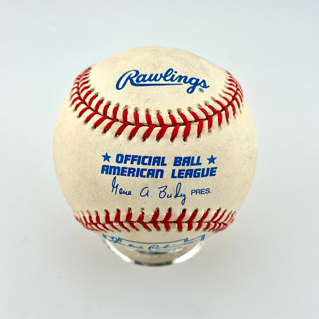 A Rawlings official American League baseball displayed on a clear stand against a light gray background.