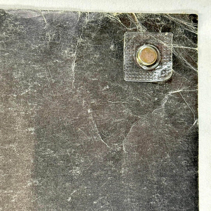 Top left corner with creases and scratches. 