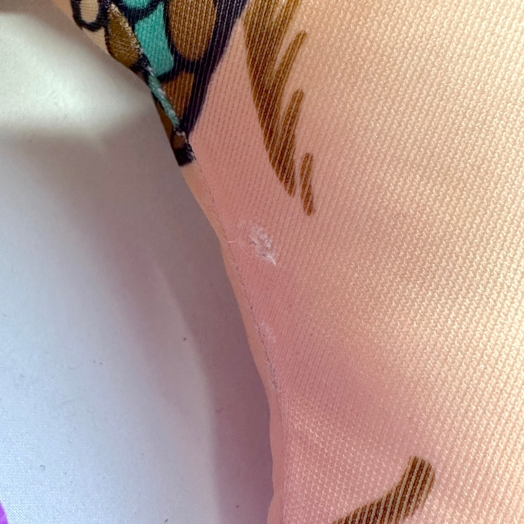 Close-up of a fabric with brown patterns on a white background