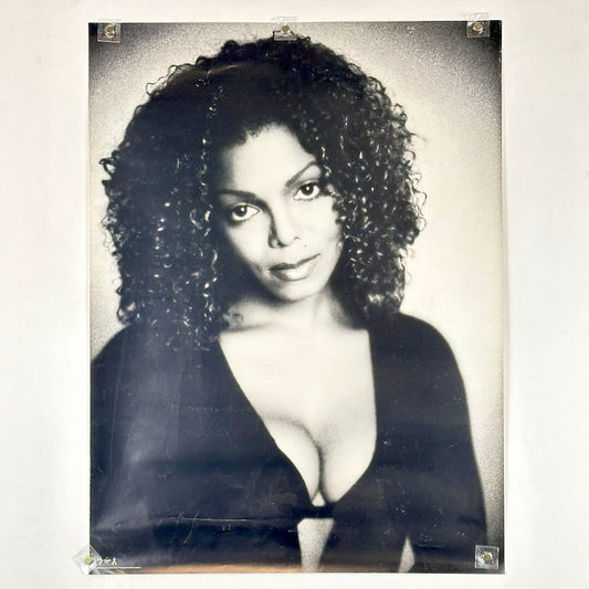 Black and white poster portrait of Janet Jackson in black shirt. 