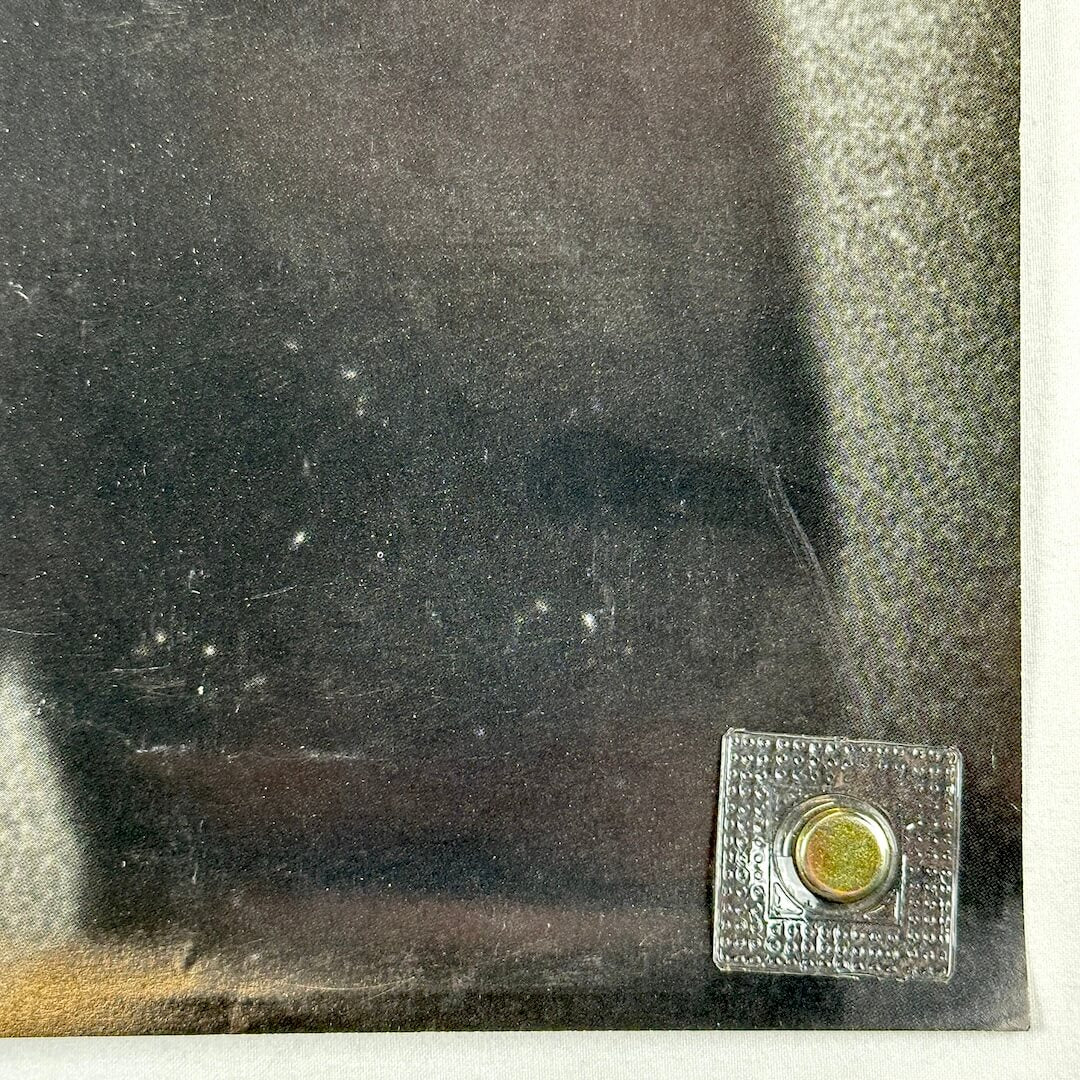 Bottom right corner of poster with light scratches.