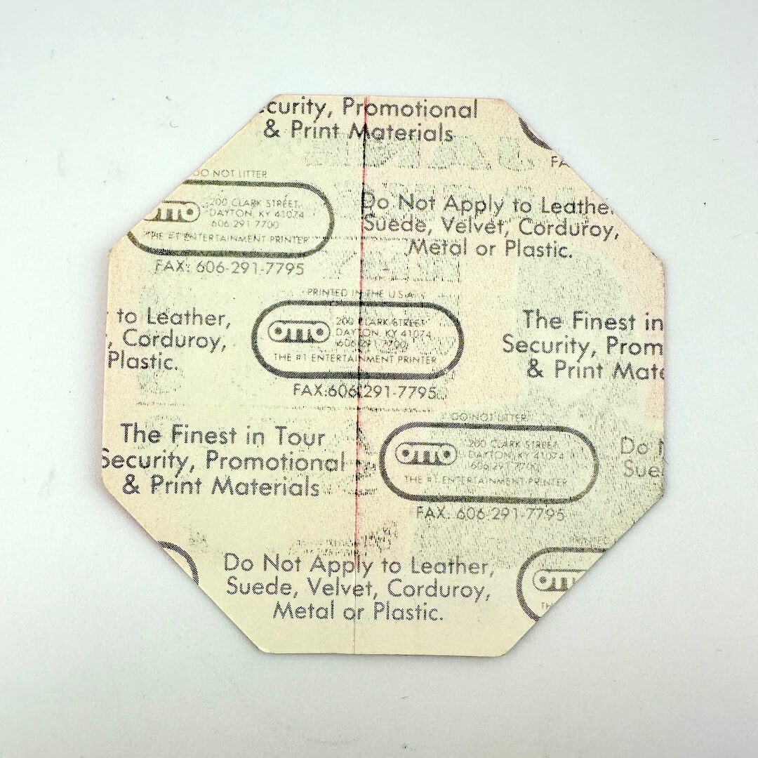Reverse side of pass to show intact backing against white background.