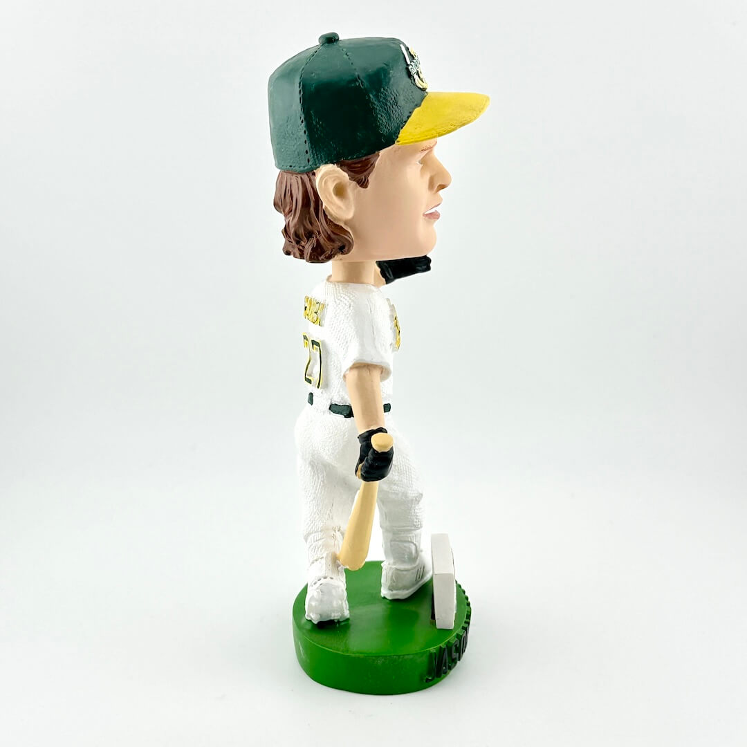 Baseball bobblehead figure with green cap and white uniform on a white background