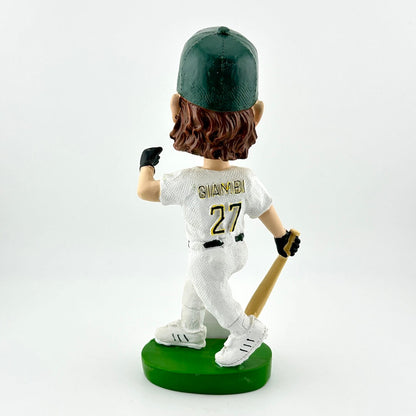 Bobblehead of a baseball player in a white uniform with green cap and bat, on a white background