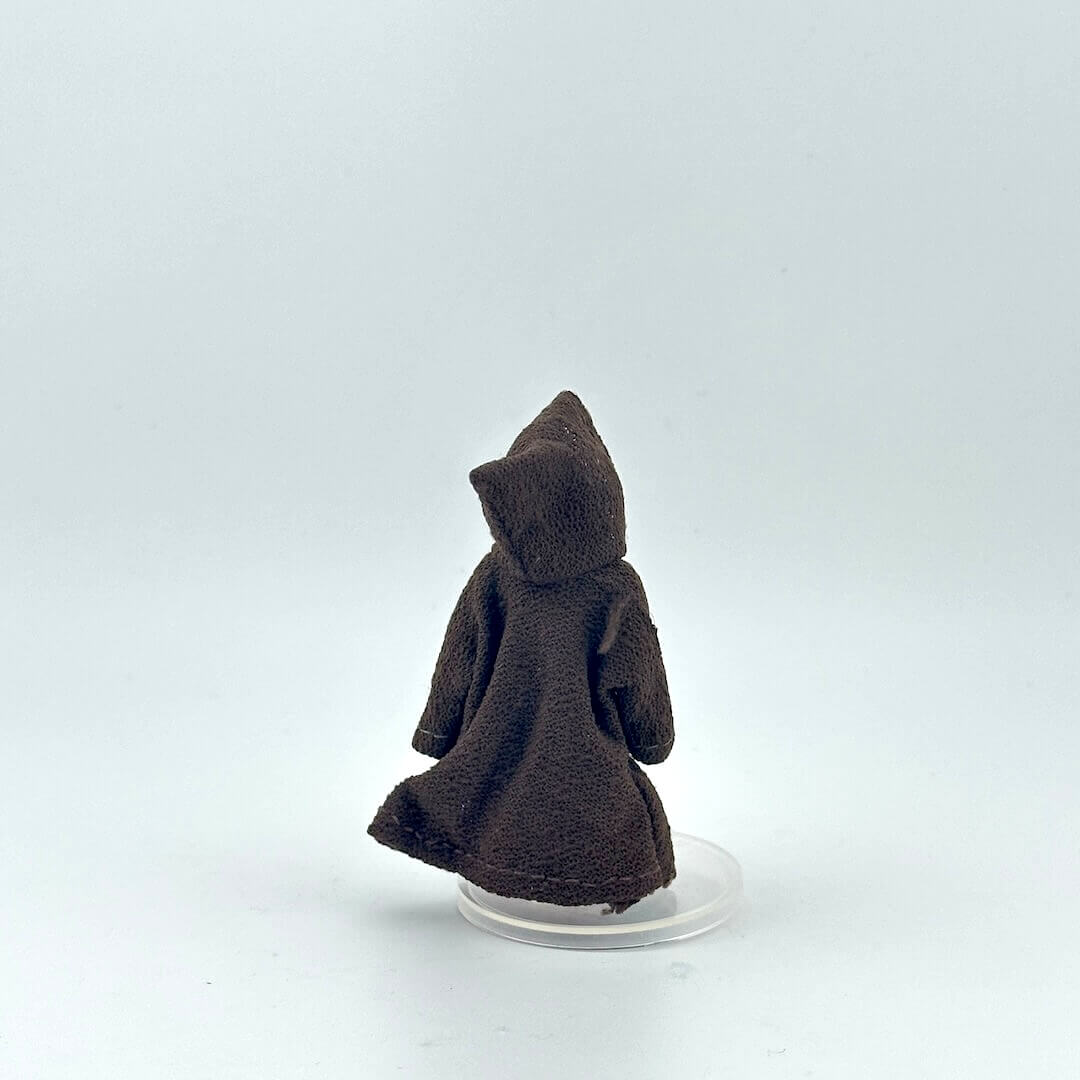 Brown robed action figure on a white background