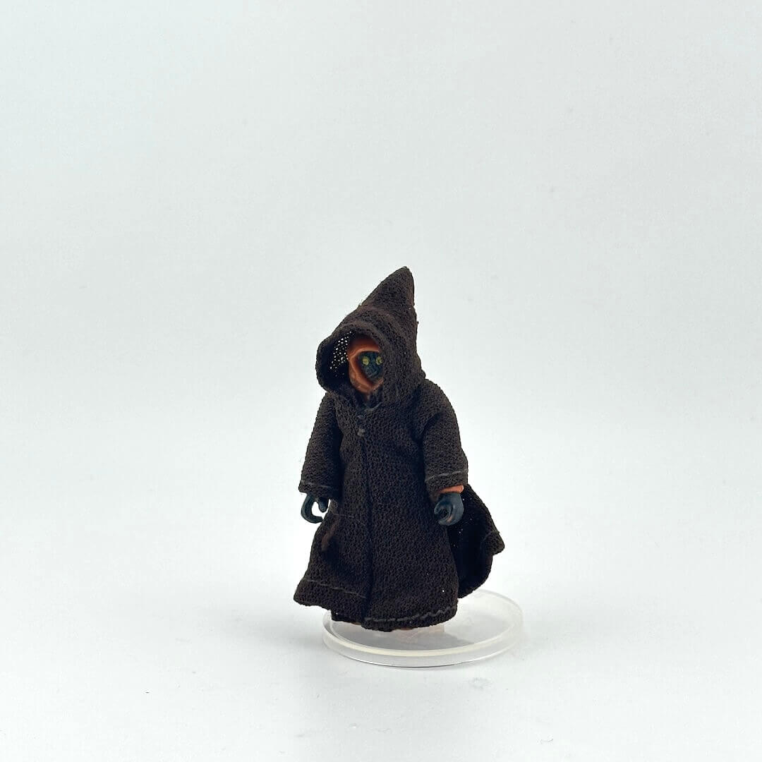Brown robed action figure on a white background