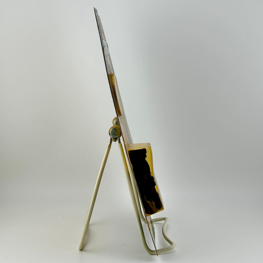 Side view of Star Wars action figure still in packaging on easel against white background. 