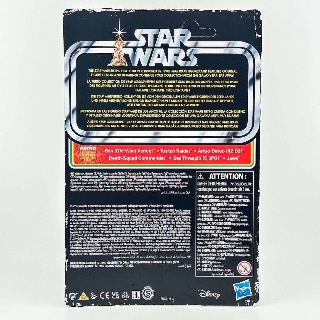 The back of a Star Wars toy packaging card, featuring product details, warnings, and logos on a black background.