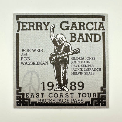 Jerry Garcia Band backstage pass with a silhouette of a person playing guitar on a light gray background