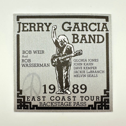Jerry Garcia Band backstage pass with a silhouette of a person playing guitar on a light gray background