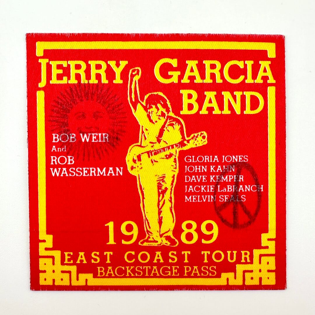 Jerry Garcia Band backstage pass with red and yellow design on a white background