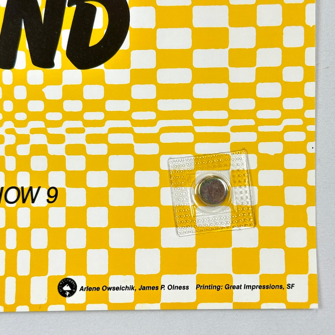 Yellow and white checkered pattern with text and a clear square object on a gray background