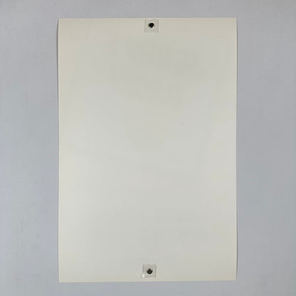 White sheet of paper with two magnets on a gray background