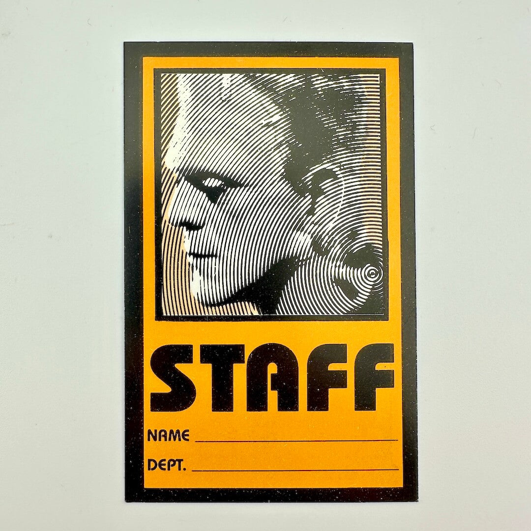 Staff pass with black and white graphic design on a yellow background
