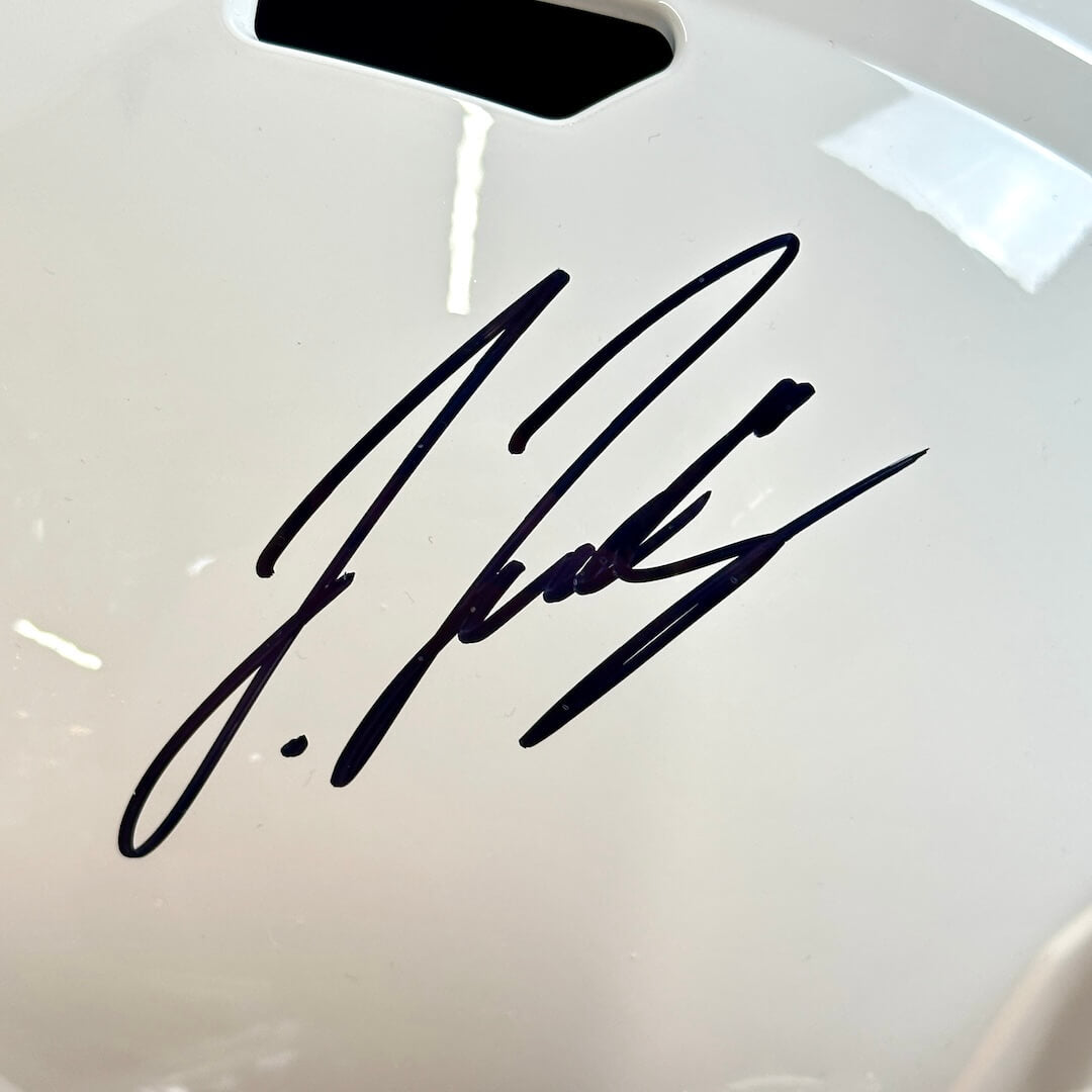 Close-up of signature in black marker. 