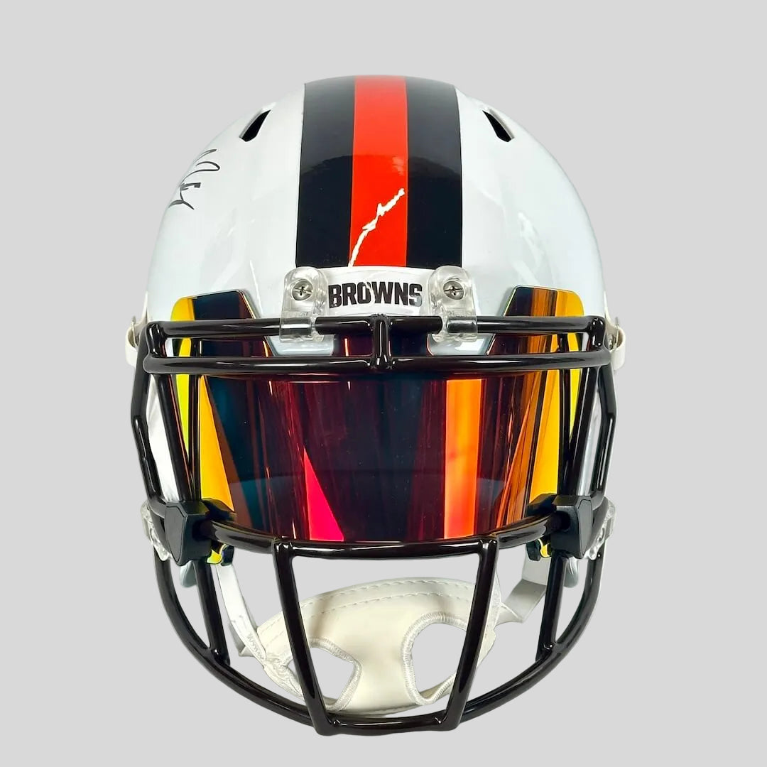 Front view of helmet with black and orange stripes down center. 