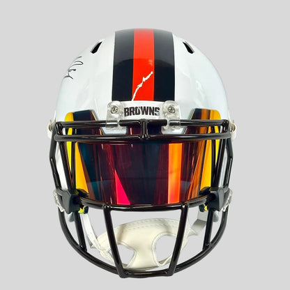 Front view of helmet with black and orange stripes down center. 