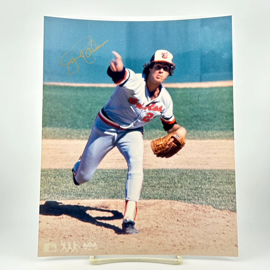 Baseball player in action on a field with a signature above