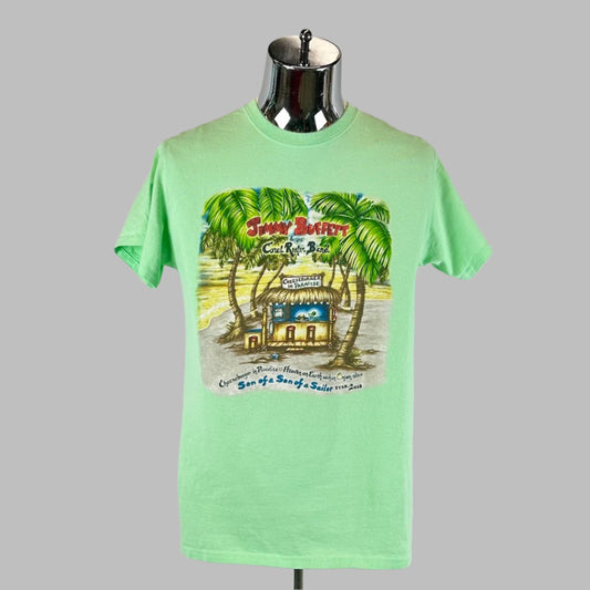 Seafoam green shirt with bungalow in center amid palm trees with Jimmy Buffett in the leaves, tour information below. 