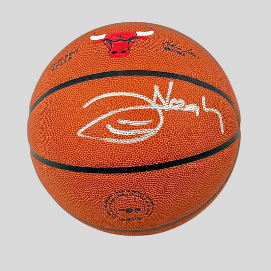 Signed basketball with a clear stand on a white background