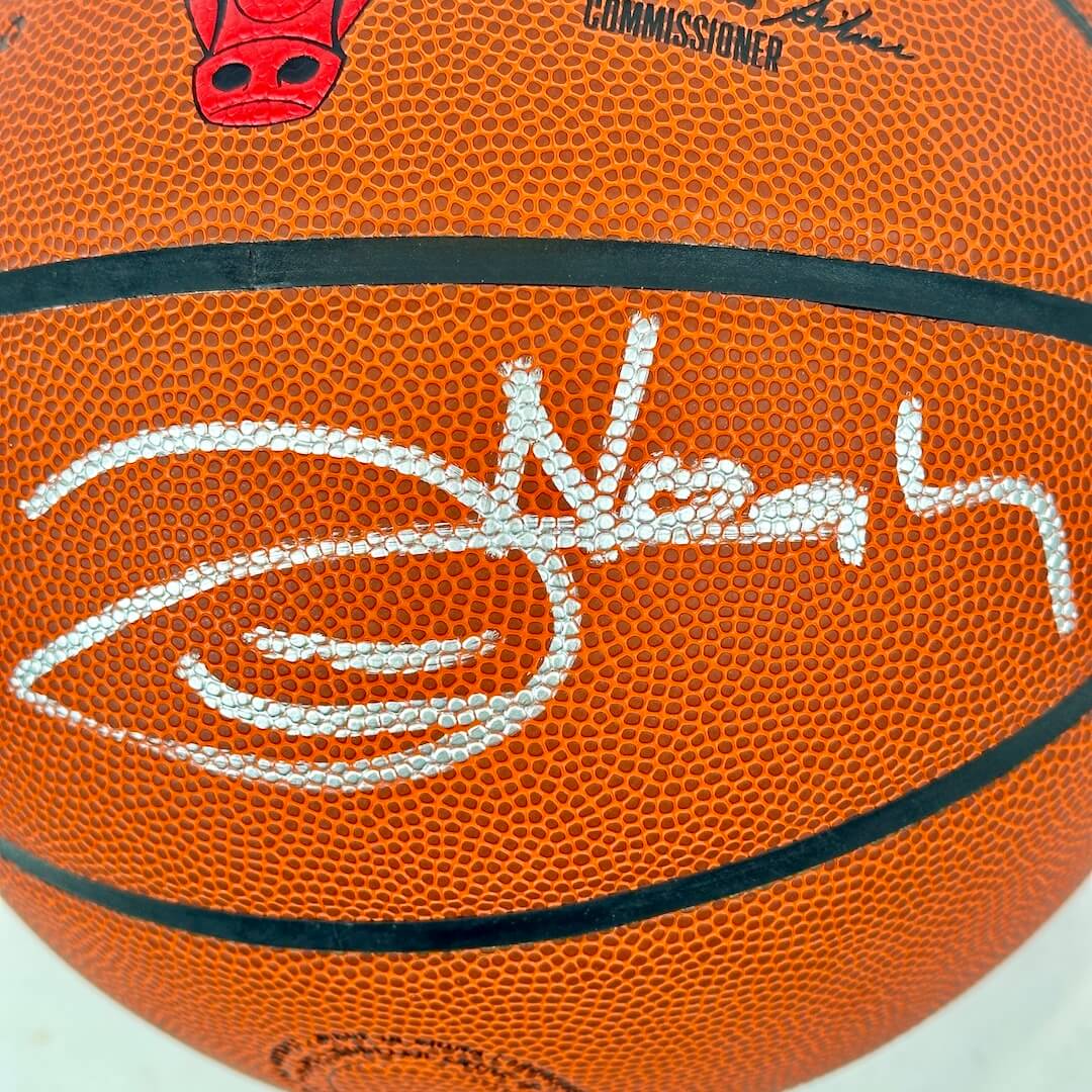 Basketball with a signature and logo on an orange background