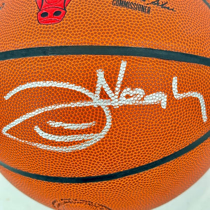 Basketball with a signature and logo on an orange background