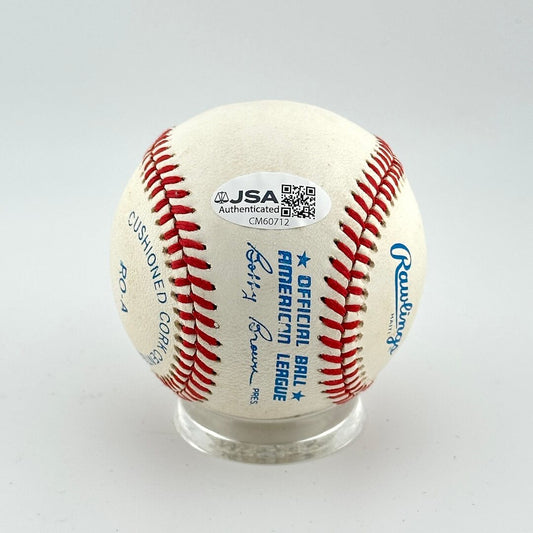 Baseball with JSA authentication label on a white background