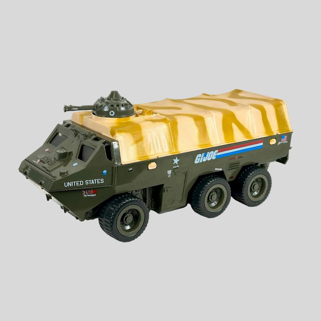 A vintage G.I. Joe vehicle with green body and desert camouflage canopy with green gun turret attached at top. 