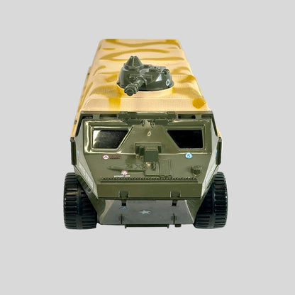 A miniature military toy vehicle, resembling an armored transport truck, painted in olive green and tan camouflage.
