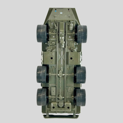 An underside view of a military armored vehicle model, showing detailed chassis, suspension, and six dark wheels.