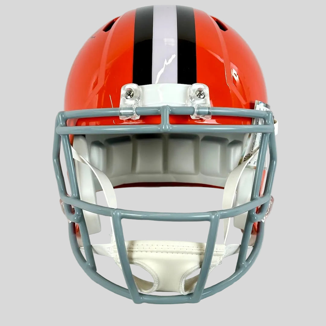 Football helmet with orange and black design on a white background
