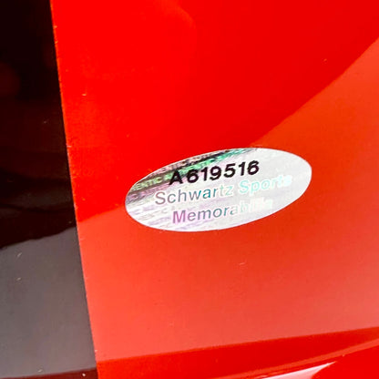 Orange helmet with a label featuring 'A619516' and 'Schwartz Sport Memorabilia'.