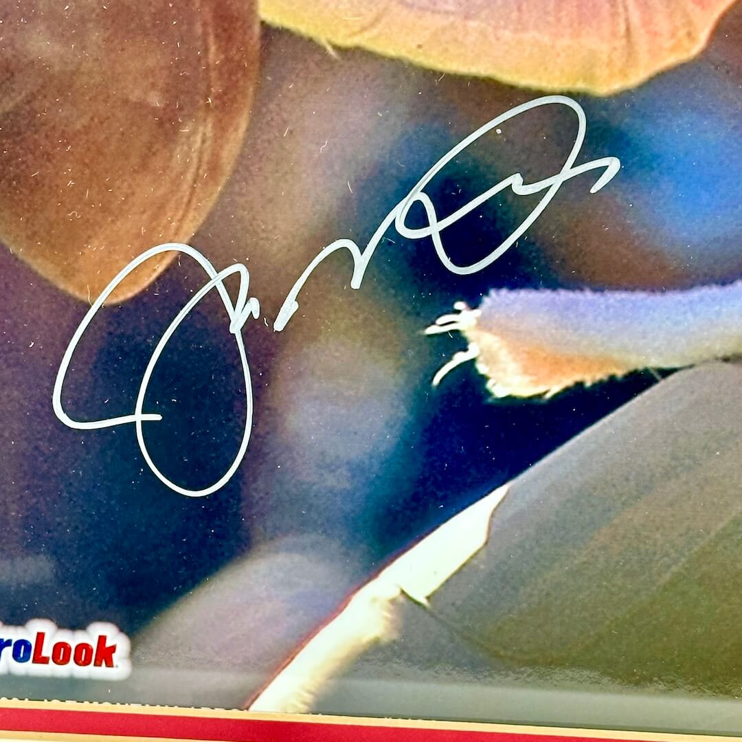 Close-up of silver marker signature on photo. 