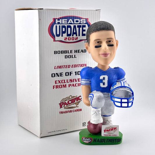 Bobblehead of football player holding helmet with box against white background. 