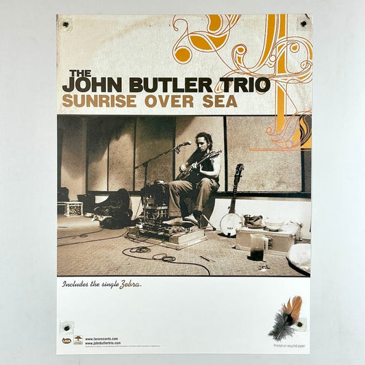 Poster with image of musician playing on the street with text above and white banner below. 