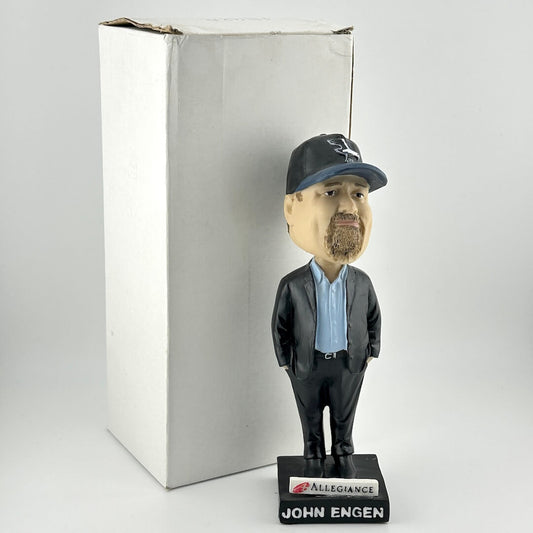 Bobblehead figure of a man wearing a cap and suit with 'Allegiance' branding, on a white background.