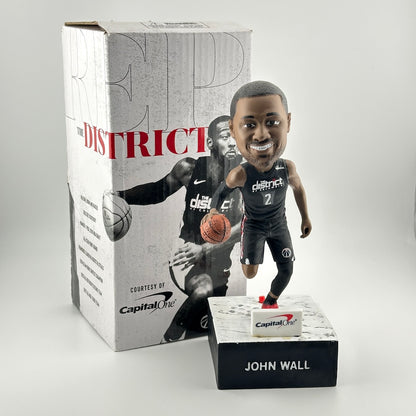 Bobblehead figure of a basketball player in front of a branded box