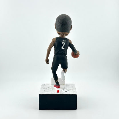 Bobblehead figure of a basketball player in a black jersey with the number 2 on a white background