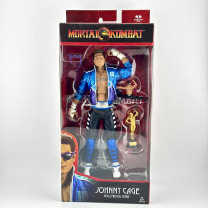 Mortal Kombat Johnny Cage action figure in its original window box packaging, featuring accessories inside.